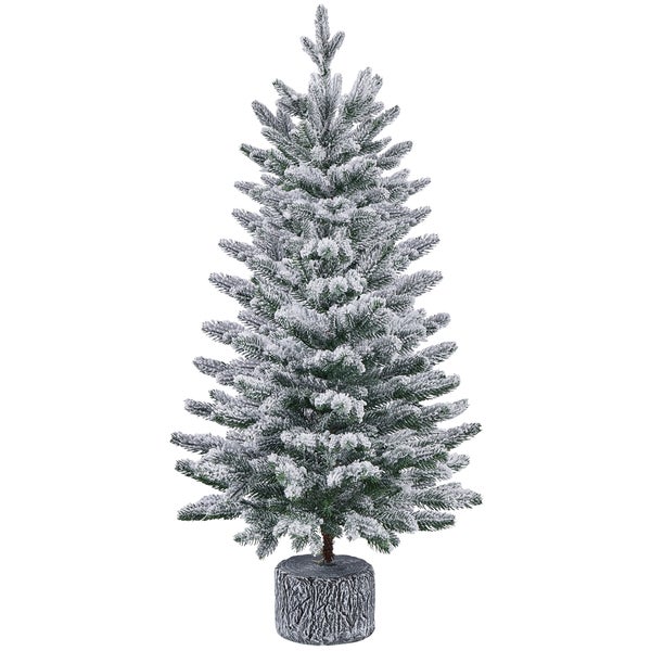 Künstlicher Weihnachtsbaum mit Schnee auf Baumstammfuß
