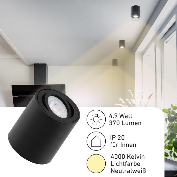Schwarze zylindrische LED-Aufbauleuchte in einem hellen Raum, 4,9 Watt, 370 Lumen, Schutzart IP 20 für innen, 4000 Kelvin neutralweiße Lichtfarbe.