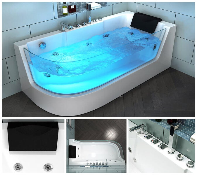 Moderne Whirlpool Badewanne mit Glasfront integrierten Armaturen und Kopfstütze in einem gefliesten Badezimmer.