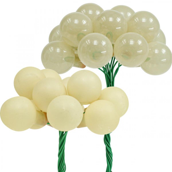 Zwei Deko-Zweige mit cremefarbenen, runden LED-Lichtern.