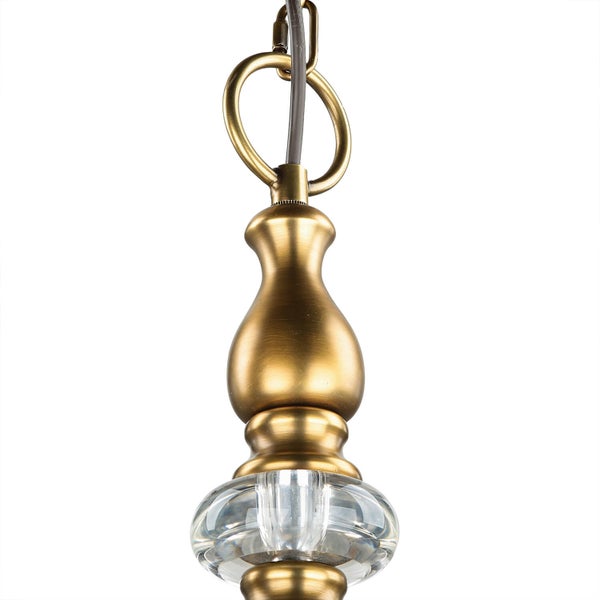 Detailaufnahme einer Pendelleuchte mit goldenem Aufhängungssystem und Glaskörper