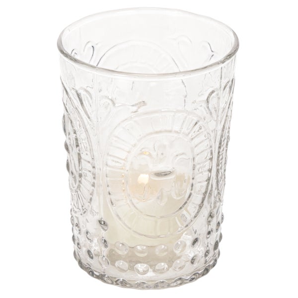 Windlicht aus Glas mit Reliefmuster und Kerze.