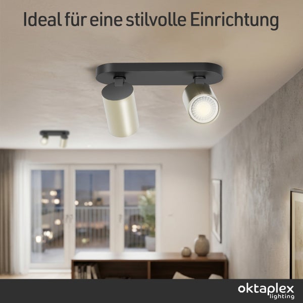 Moderner zweiflammiger Deckenstrahler aus Metall in einem hellen Wohnzimmer mit Fensterfront und Sideboard. Oktaplex Lighting Logo.