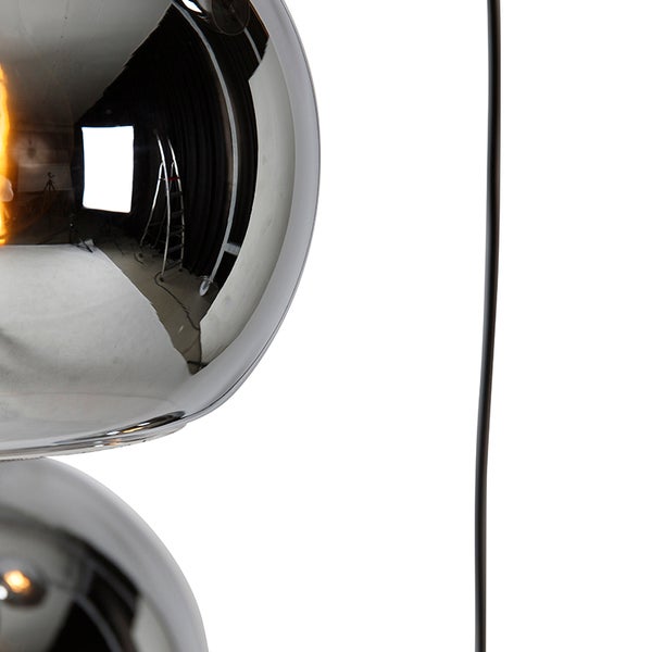 Detailansicht eines kugelförmigen, reflektierenden Lampenschirms mit Spiegeleffekt und schwarzem Kabel.