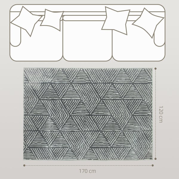 Rechteckiger Teppich mit geometrischem Dreiecksmuster vor einem Sofa, Maße 170 mal 120 Zentimeter.