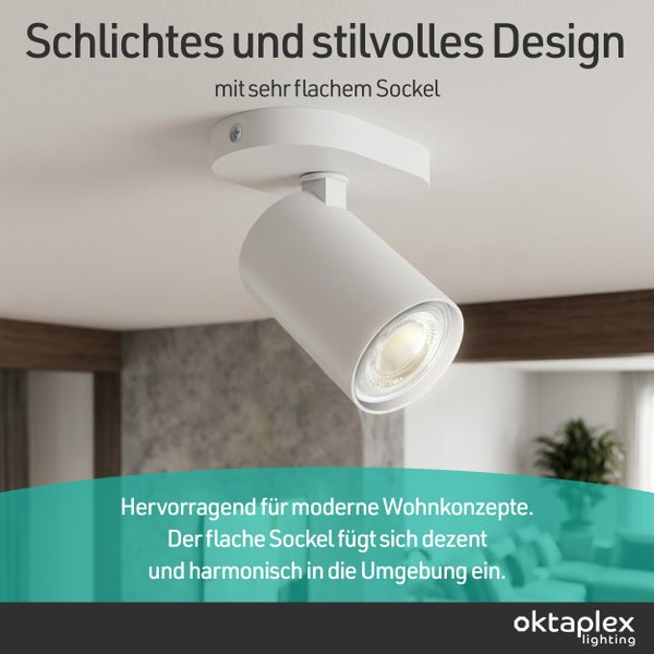 Moderner Deckenstrahler mit flachem Sockel und zylindrischem Strahlerkopf in einem hellen Wohnambiente. Oktaplex Lighting Logo.