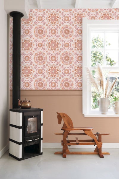 Wohnraum mit Kaminofen, hölzernem Schaukelpferd und gemusterter Tapete