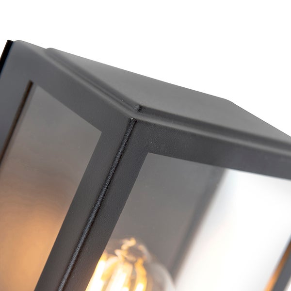 Nahaufnahme einer modernen Außenwandleuchte aus schwarzem Metall mit Glaseinsätzen und sichtbarem LED-Leuchtmittel.