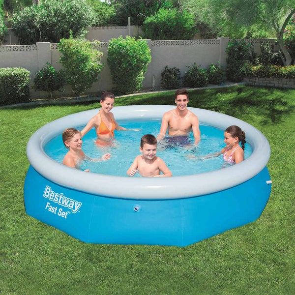 Bestway Fast Set Aufstellpool im Garten mit einer fuenfkoepfigen Familie im Wasser. Rundes blaues Schwimmbecken mit aufblasbarem Ring auf einer Wiese.