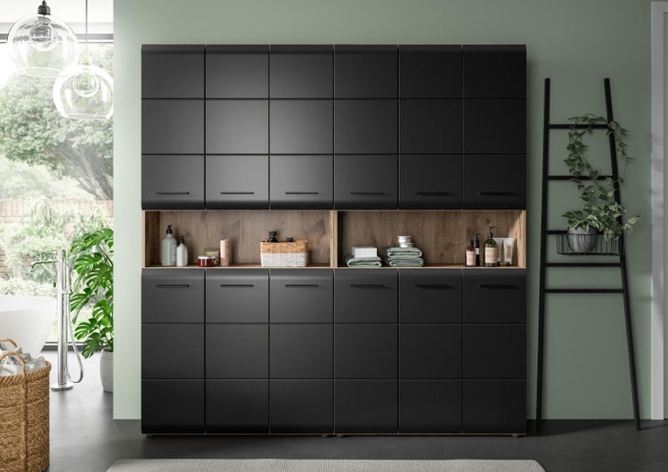 Moderner schwarzer Badezimmerschrank mit offenem Holzregal und vielen Staufächern in einem hellen, organisierten Badezimmer.