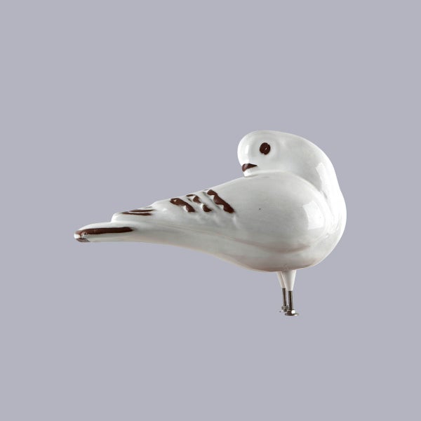 Dekorative, weiße Vogelfigur aus Keramik mit glänzender Oberfläche und Metallschraubfüßen.