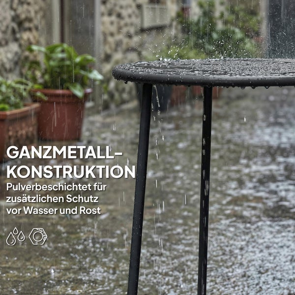 Schwarzer Beistelltisch aus Metall neben einem Sofa, dekoriert mit einer Lampe, Büchern und einer Pflanze.