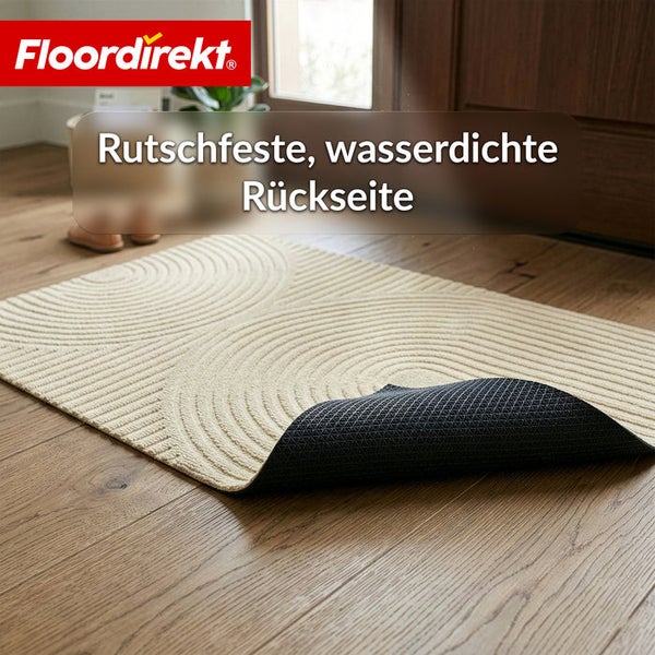 Beige Fußmatte mit kreisförmigem Muster auf Holzboden, rutschfeste und wasserdichte Rückseite. Floordirekt Logo.
