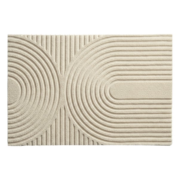 Rechteckige Badematte in Creme mit geometrischem dreidimensionalem Reliefmuster aus konzentrischen Halbkreisen und Linien.