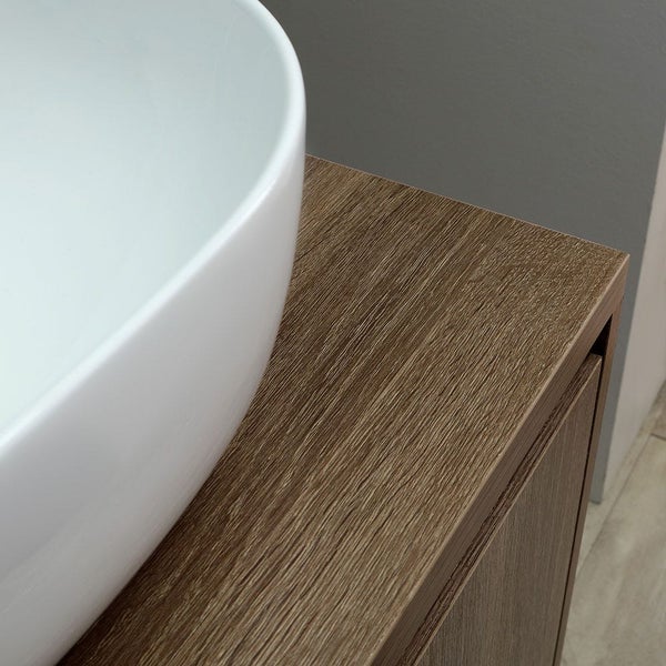Detailansicht eines Badezimmers mit einem weißen Aufsatzwaschbecken auf einem Holzunterschrank