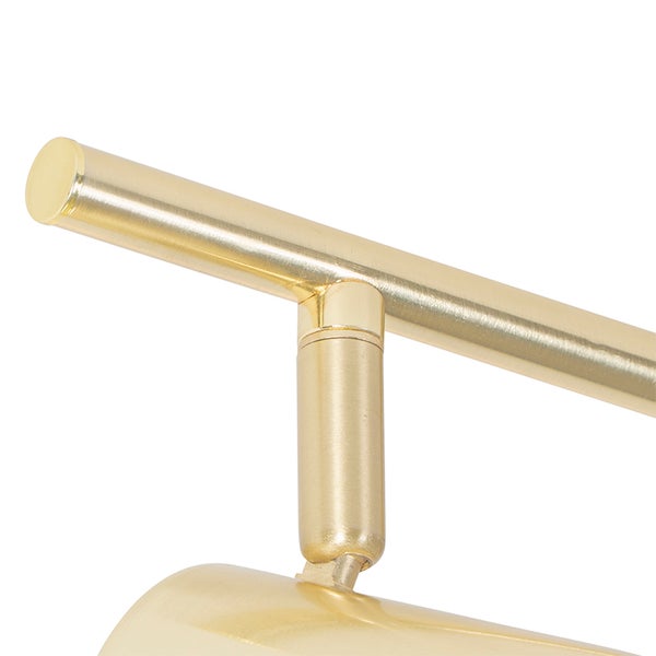 Detailaufnahme einer goldenen Lampenhalterung.