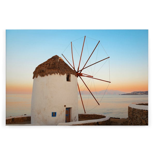 Wandbild mit einer Windmühle vor einer Küstenlandschaft im Sonnenuntergang