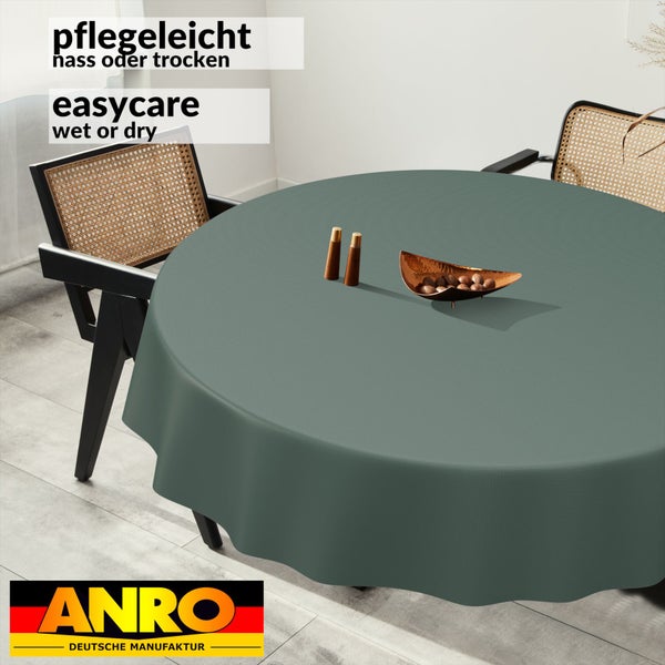 Rundes Tischtuch auf einem Esstisch mit Stühlen, pflegeleichte Oberfläche für Reinigung feucht oder trocken geeignet. ANRO Logo.