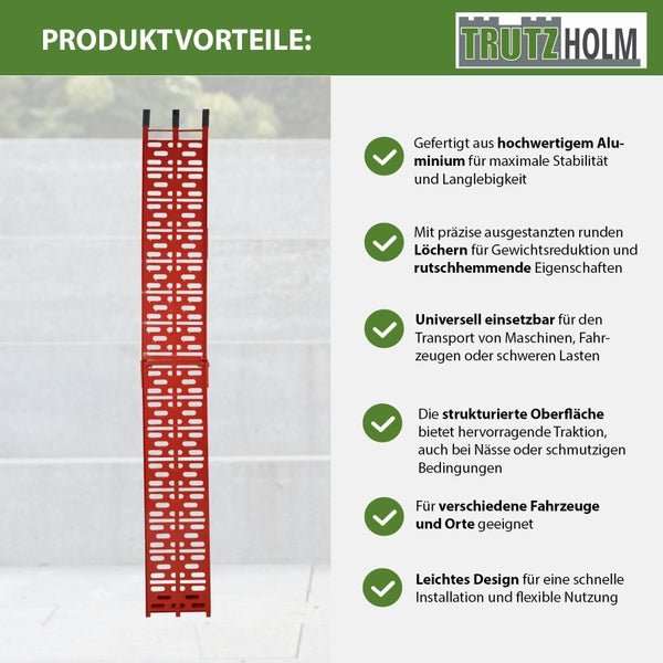 TrutzHolm Logo und eine rote Auffahrschiene aus Aluminium mit rutschhemmender gelochter Oberfläche sowie Informationen zu Stabilität und Traktion.