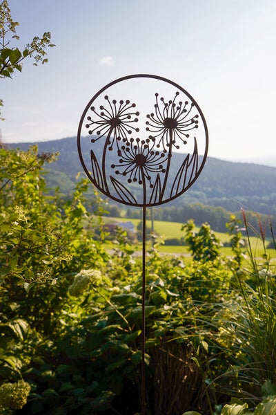 Gartenstecker aus Metall in Rost-Optik mit einem kreisförmigen Motiv von drei Pusteblumen.
