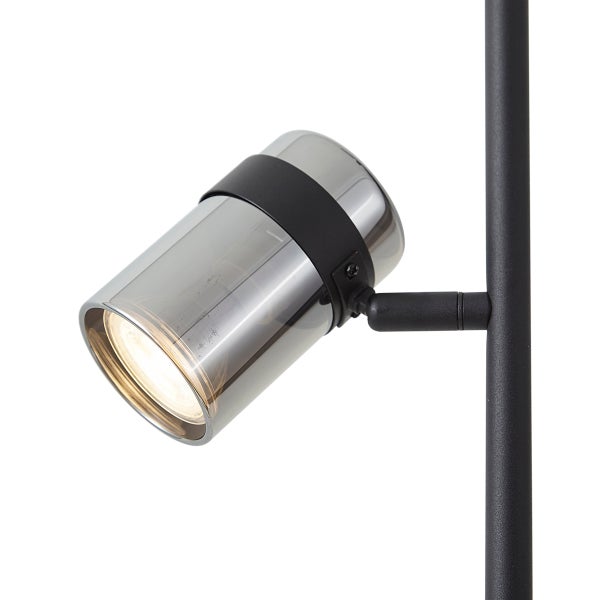 Moderner zylindrischer Strahler aus Metall und Rauchglas in Schwarz, eingeschaltet.