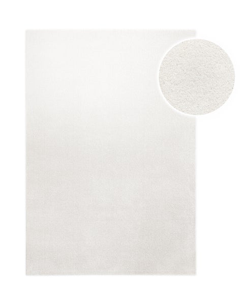 Rechteckiger weißer Teppich mit weicher Textur und Detailansicht der Fasern.