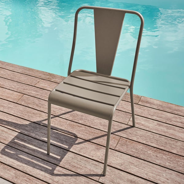 Gartenstuhl aus Metall mit Latten-Sitzfläche und hoher Rückenlehne auf einer Holzterrasse an einem Swimmingpool.