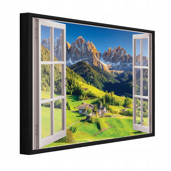 Wandbild mit Fensteroptik zeigt eine Berglandschaft in den Alpen mit Kirche und Wiesen in einem schwarzen Rahmen.