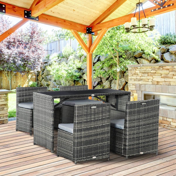 Moderne Garten-Essgruppe aus grauem Polyrattan mit Tisch und vier Stühlen mit Kissen auf einer Holzterrasse unter einem Pavillon aus Holz.