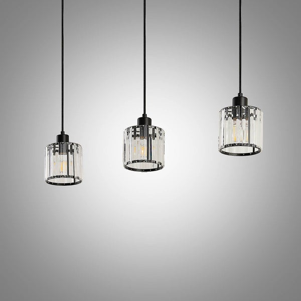 Drei Pendelleuchten mit zylindrischen Glasschirmen und schwarzer Aufhängung