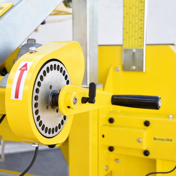 Gelbe Hebevorrichtung mit Handkurbel und rotem Pfeil nach oben