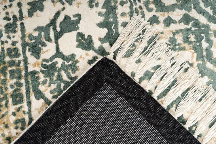 Teppich mit weißen Fransen, grünem Vintage-Muster und rutschfester schwarzer Rückseite.