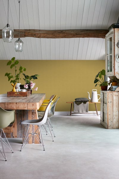 Heller Raum mit Esstisch, Stühlen, Bank und Dekoration für ein freundliches Ambiente.