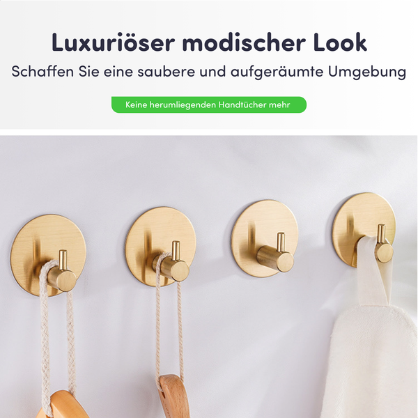 Vier moderne runde Wandhaken aus gebürstetem Metall an einer Wand mit einem Handtuch und Utensilien für eine aufgeräumte Umgebung.