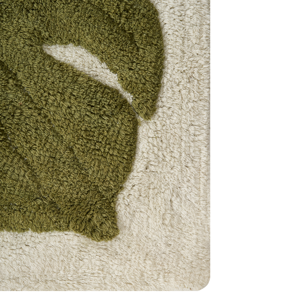 Detaillierte Ansicht eines flauschigen Badezimmervorlegers mit Blattmotiv und strukturierter Textur.