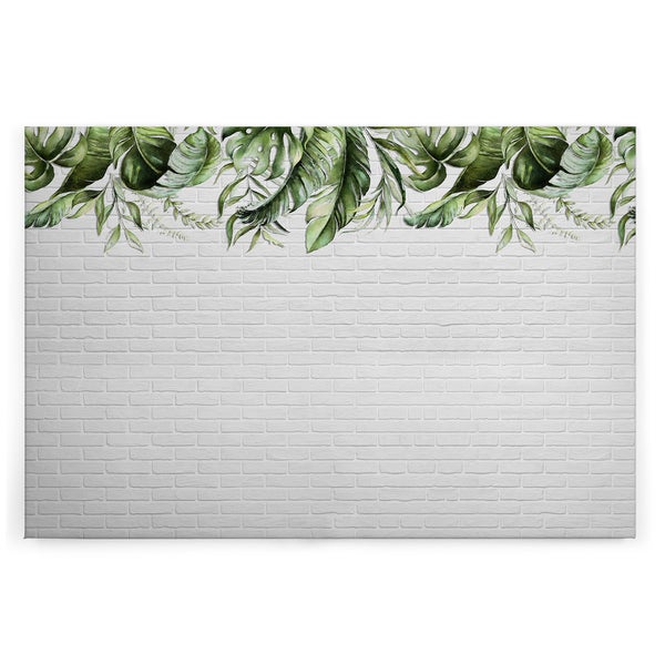 Wandbild mit Motiv von tropischen Monstera Blättern vor einem gemauerten Hintergrund