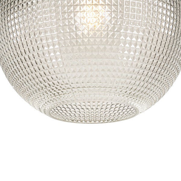 Detailaufnahme einer klaren Glasleuchte mit einem quadratischen Rautenmuster.