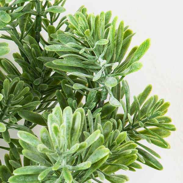 Künstliche Ranunkel mit rosa-grünen Blütenblättern, grünen Blättern und einem naturgetreuen Stiel.