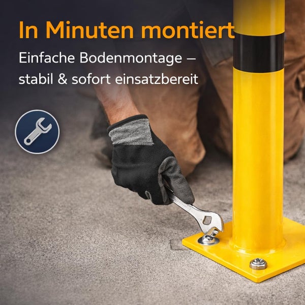 Montage eines Schutzpfostens auf festem Untergrund mit einem Schraubenschlüssel.