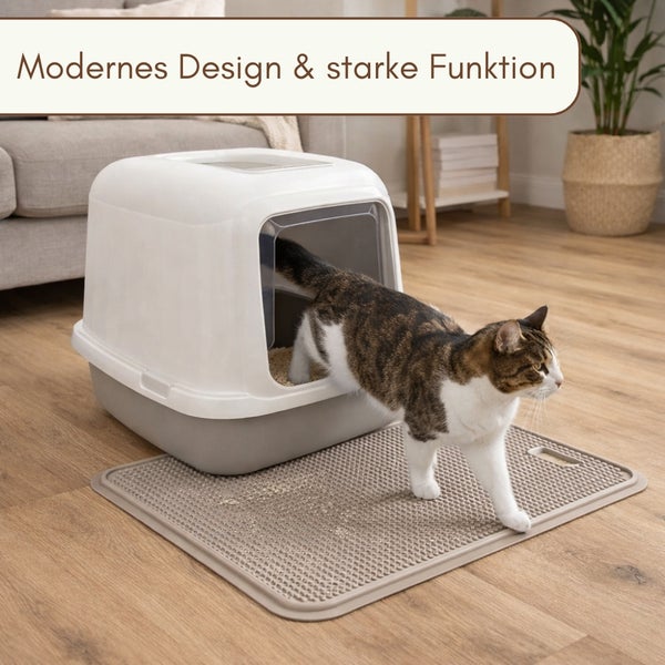 Eine Katze verlässt eine moderne Haubentoilette mit passender Katzenstreumatte in einem Wohnraum.