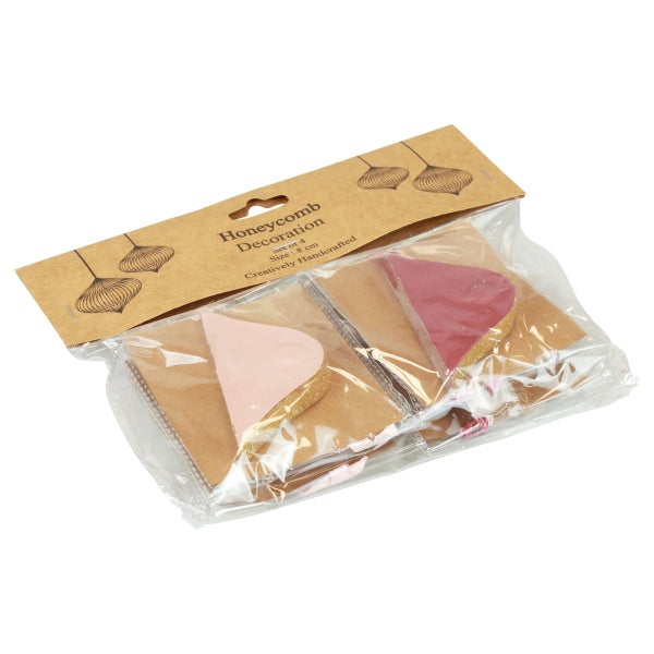 Packung mit vier Wabendekorationen, Größe acht Zentimeter.