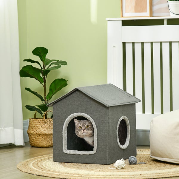 Katze in einem grauen Katzenhaus im Hausdesign mit zwei Eingängen.
