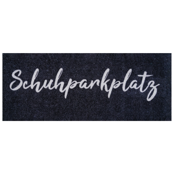 Schuhmatte mit dem Schriftzug Schuhparkplatz in Schreibschrift.