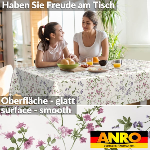 Tischdecke mit Blumenmuster in einem hellen Raum mit zwei Personen am Tisch. Glatte Oberfläche. ANRO Logo.