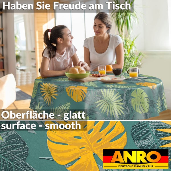 Runde Wachstuchtischdecke mit tropischem Blättermuster auf einem Esstisch in hellem Ambiente, glatte Oberfläche, ANRO Logo, deutsche Manufaktur.