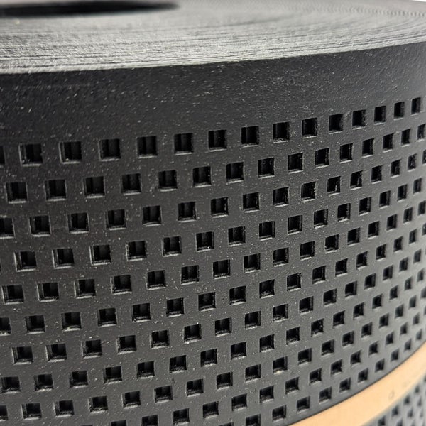 Nahaufnahme einer perforierten schwarzen Drainagematte auf einer Rolle