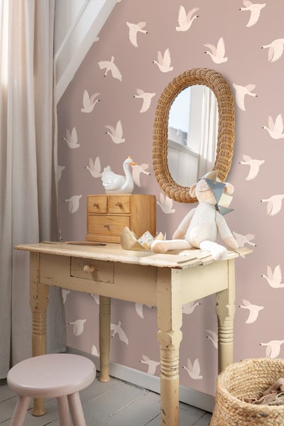 Kinderzimmer mit Mustertapete, Spiegel und Holzkommode