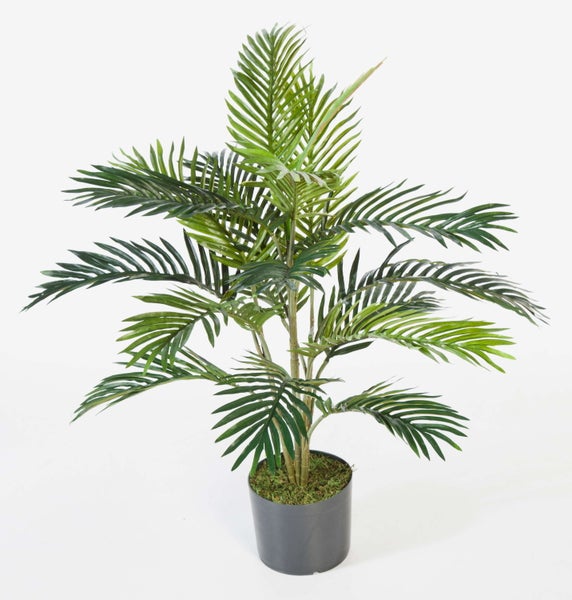 Künstliche Philodendron-Pflanze mit großen grünen gelappten Blättern in einem schwarzen Topf.