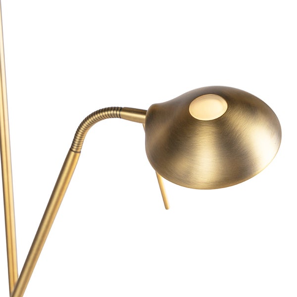 Nahaufnahme einer goldenen Stehlampe mit flexiblem Hals und LED-Leuchte