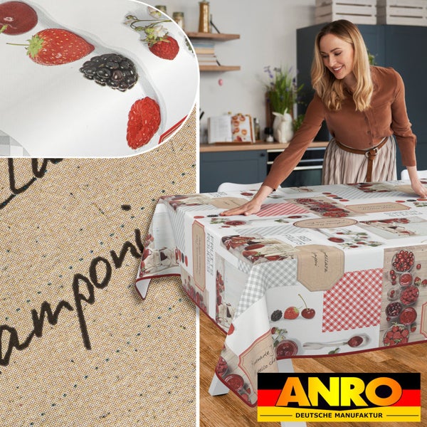 Frau legt Wachstuch-Tischdecke mit Obstmotiv auf einen Tisch